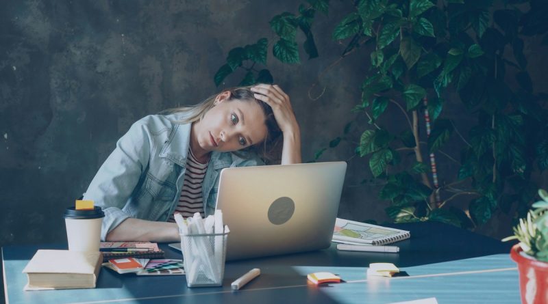 Person sitting at desk looking exhausted after deciding to quit job due to stress
