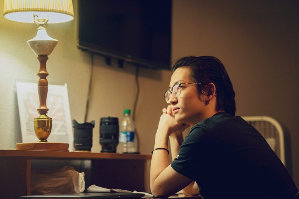 Professional reflecting on changing careers after 30 while working late at a desk