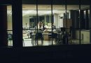 An exhausted office worker experiencing AI burnout late at night